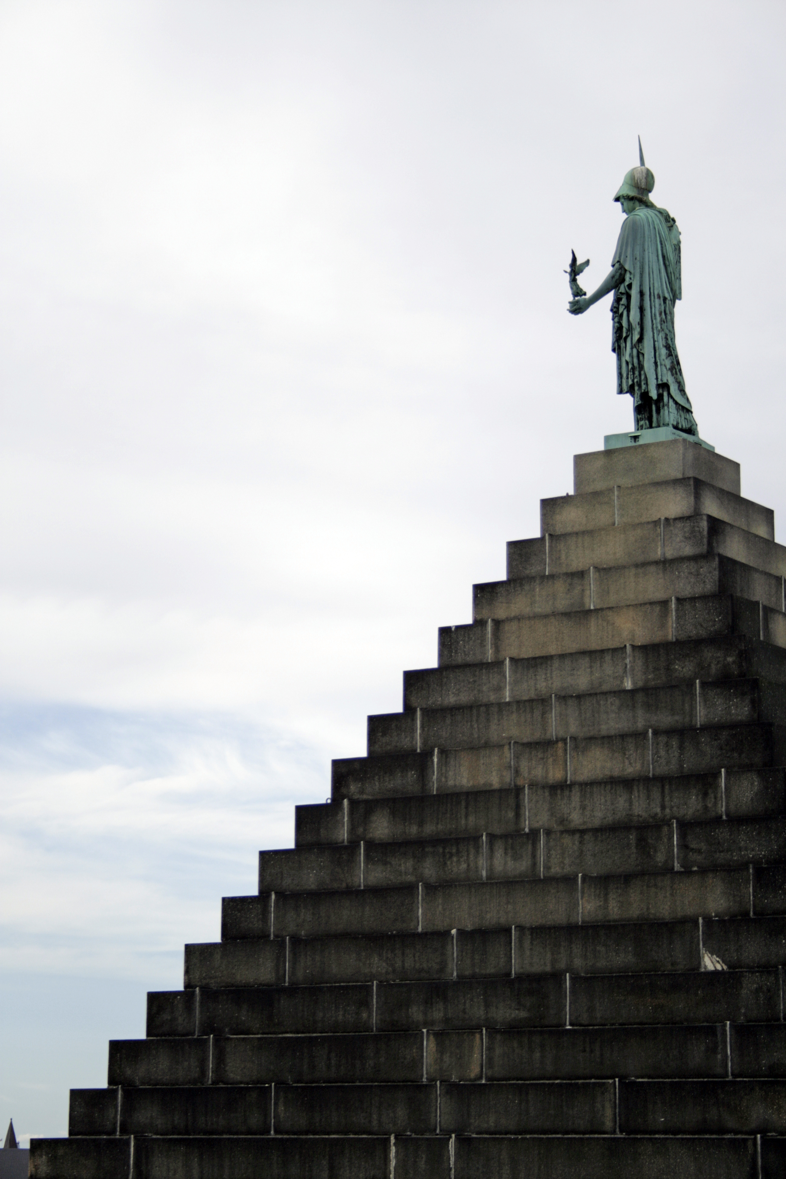 Photo of a goddess alone atop numerous steps