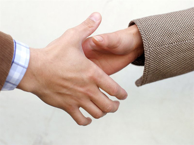 Photo of hands engaging in a handshake