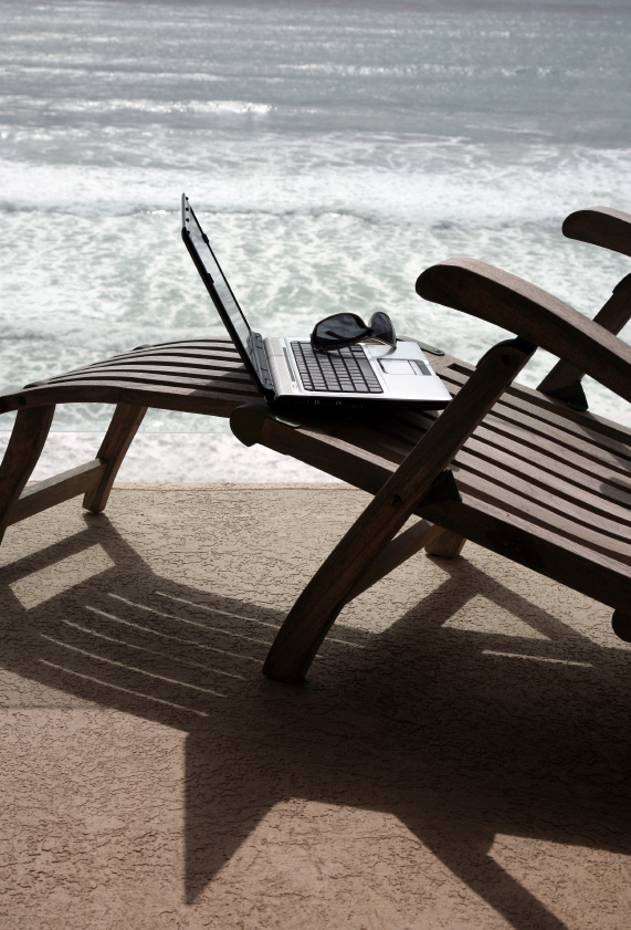 Beach chair, laptop, and sunglasses