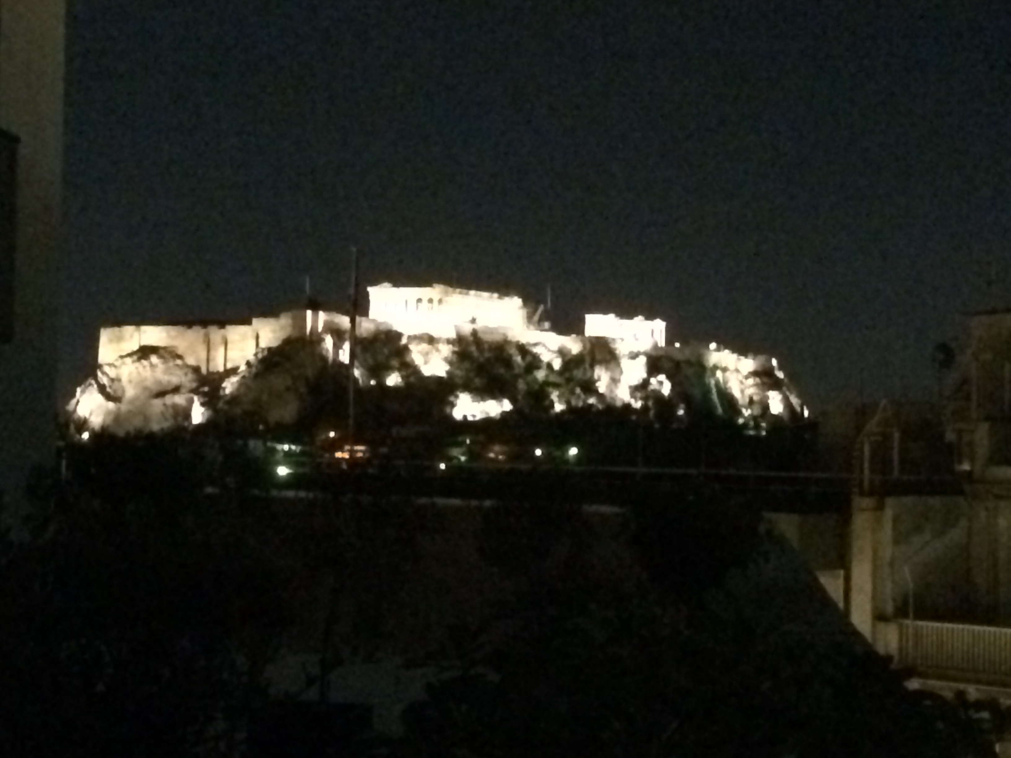 Photo of the Acropolis in Greece at night.