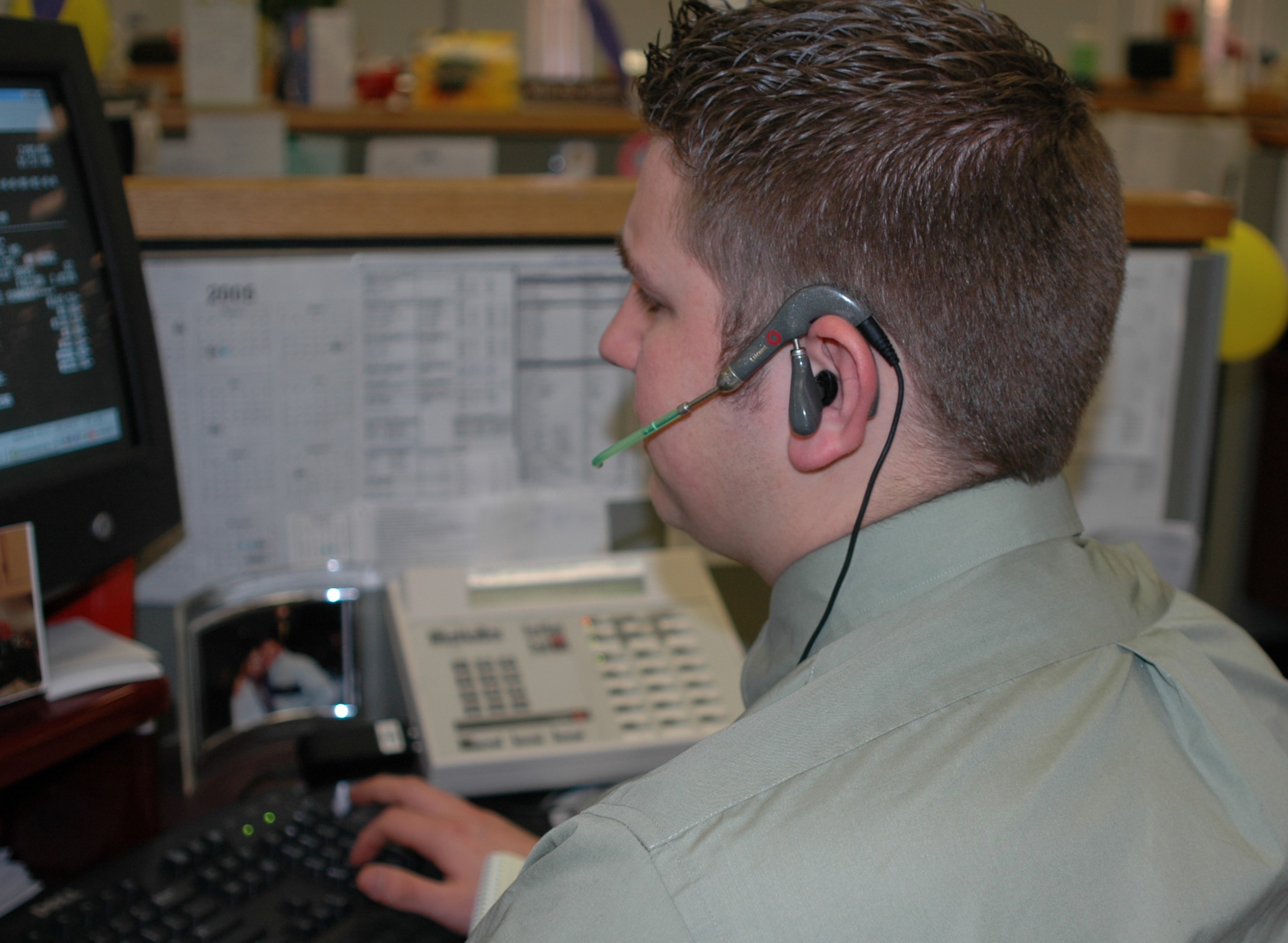 photo of side of person's head who is on a phone headset