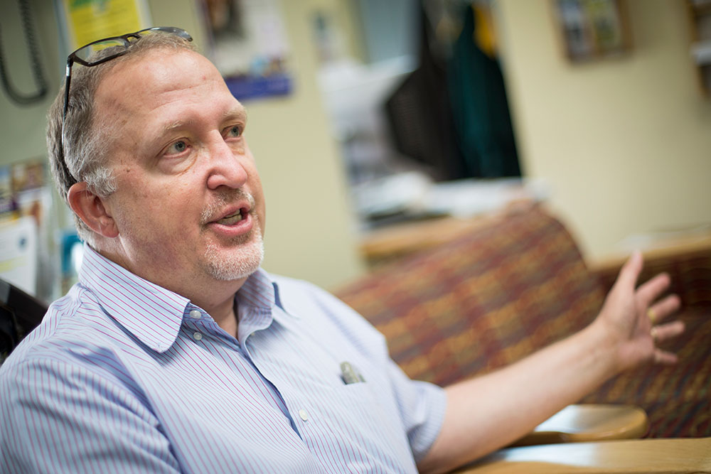 With his glasses on his head, Paul Wasko uses broad hand gestures to illustrate his point.