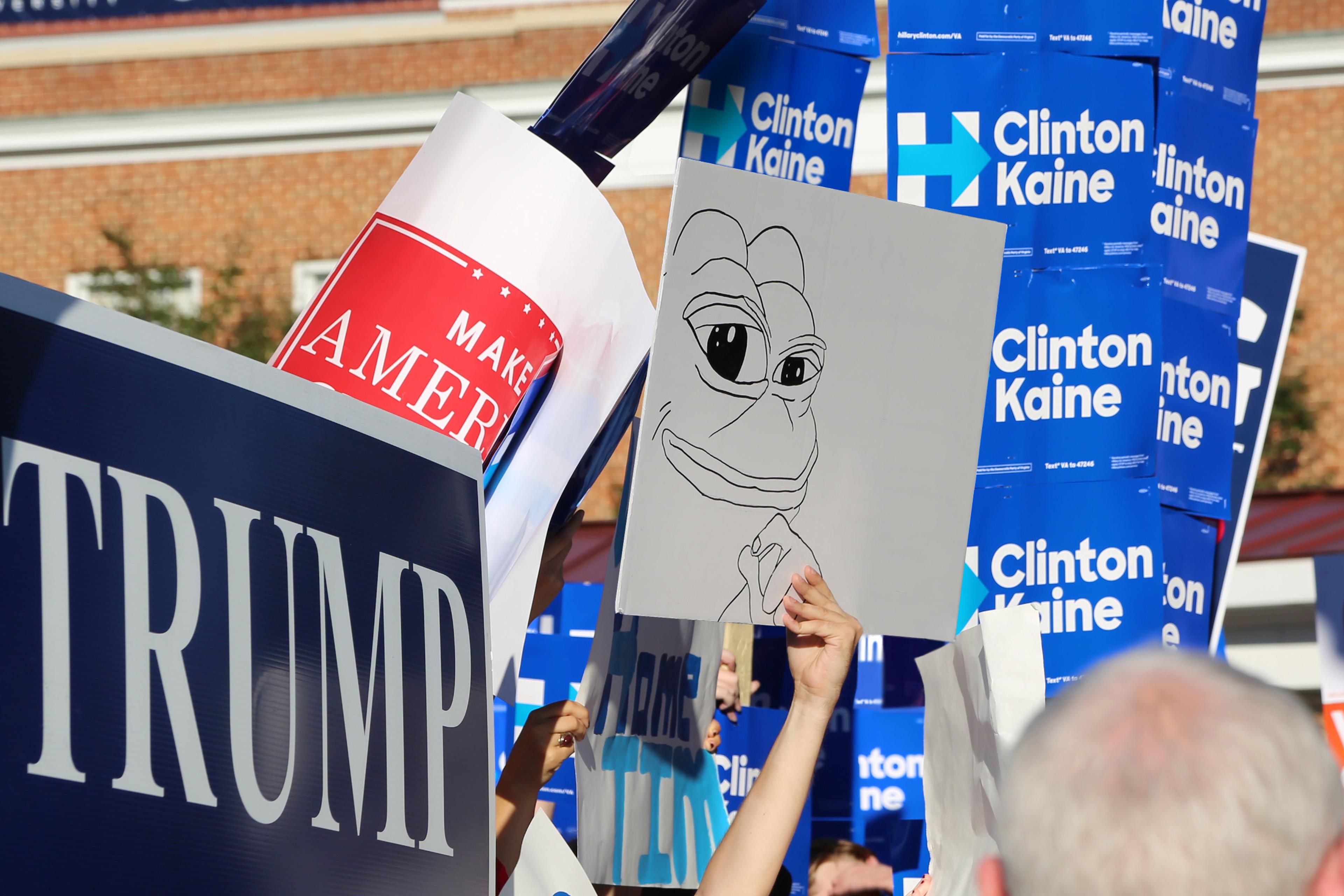 Campaign signs for Trump, Clinton/Kaine, Make America Great Again, and (inexplicably) a frog.