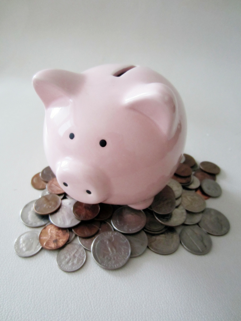 Pink piggy bank with coins