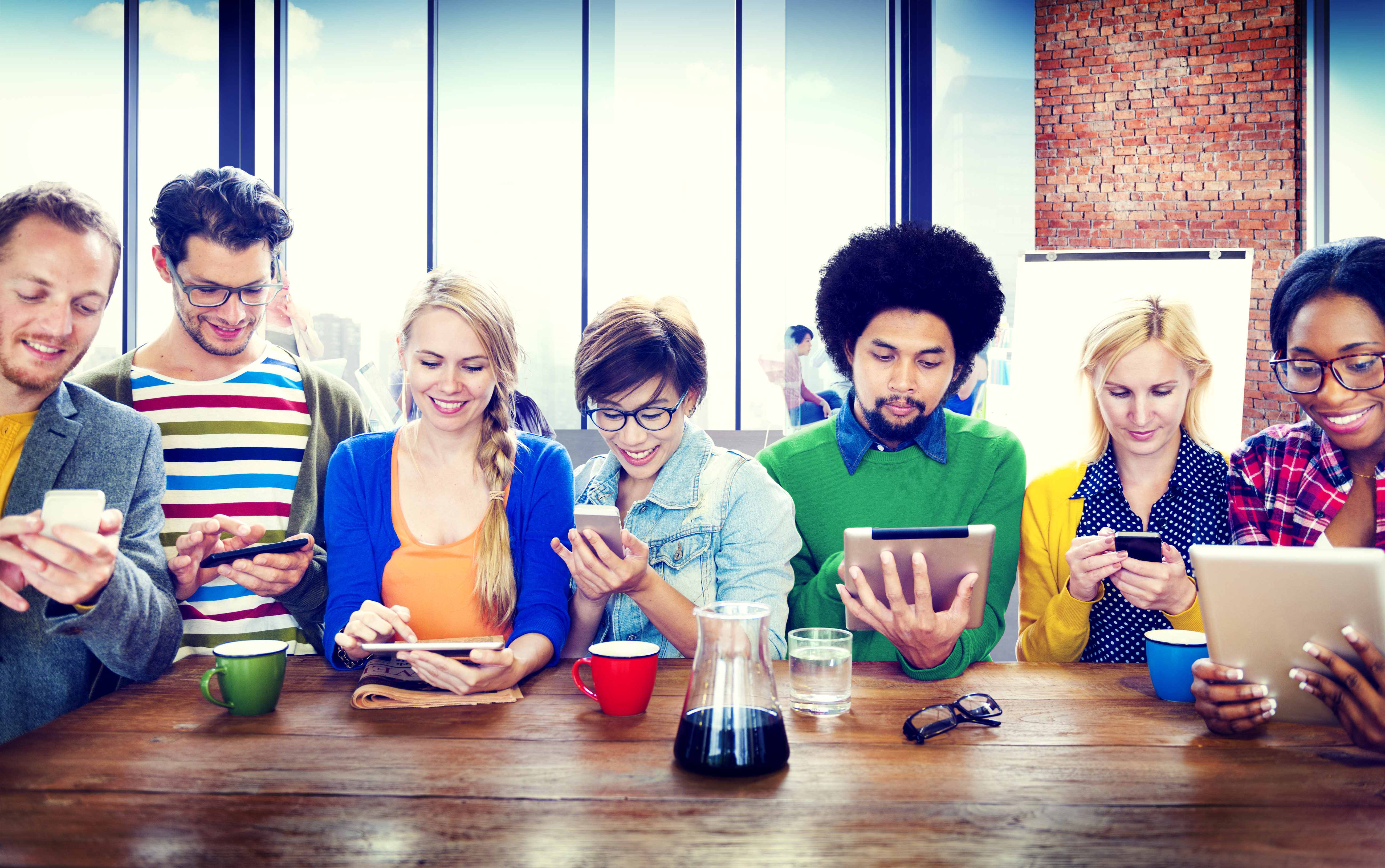 group of students with various technology devices