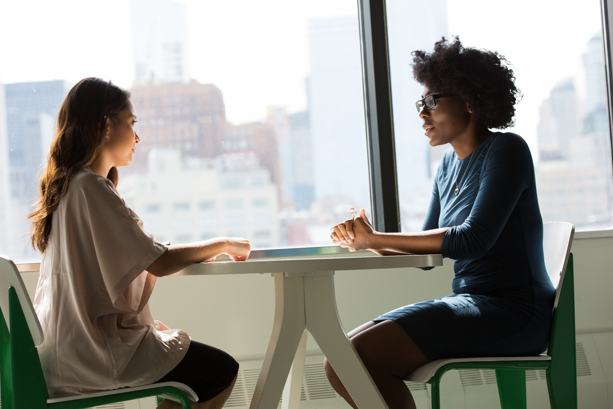 Two women sitting at a table talking