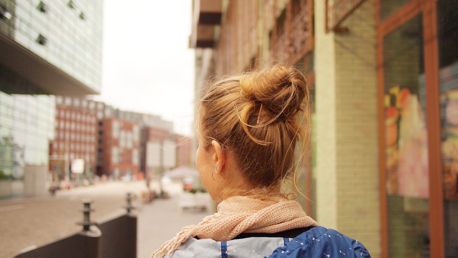 A young female looking around a city