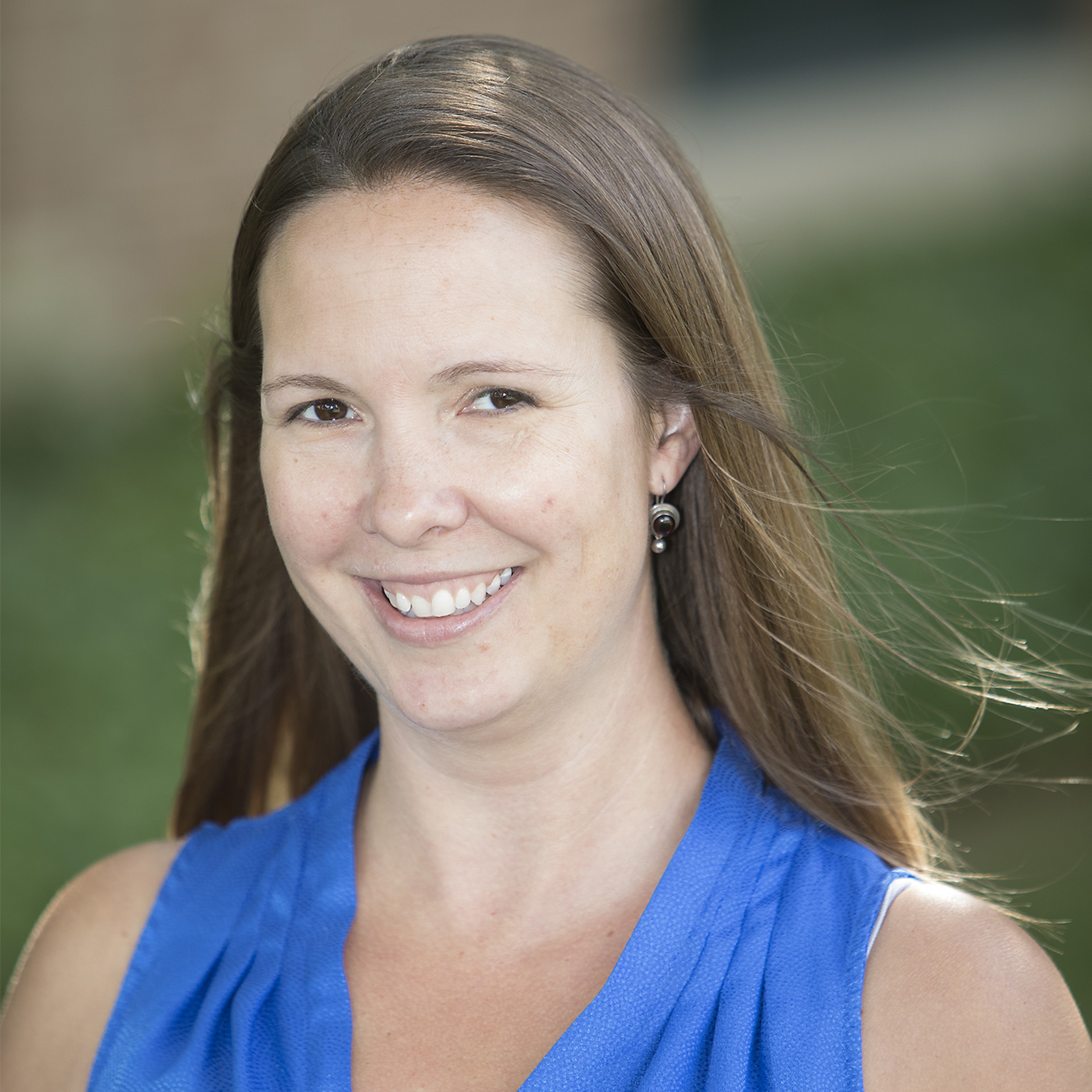 Author headshot. Jessica smiles into the camera.