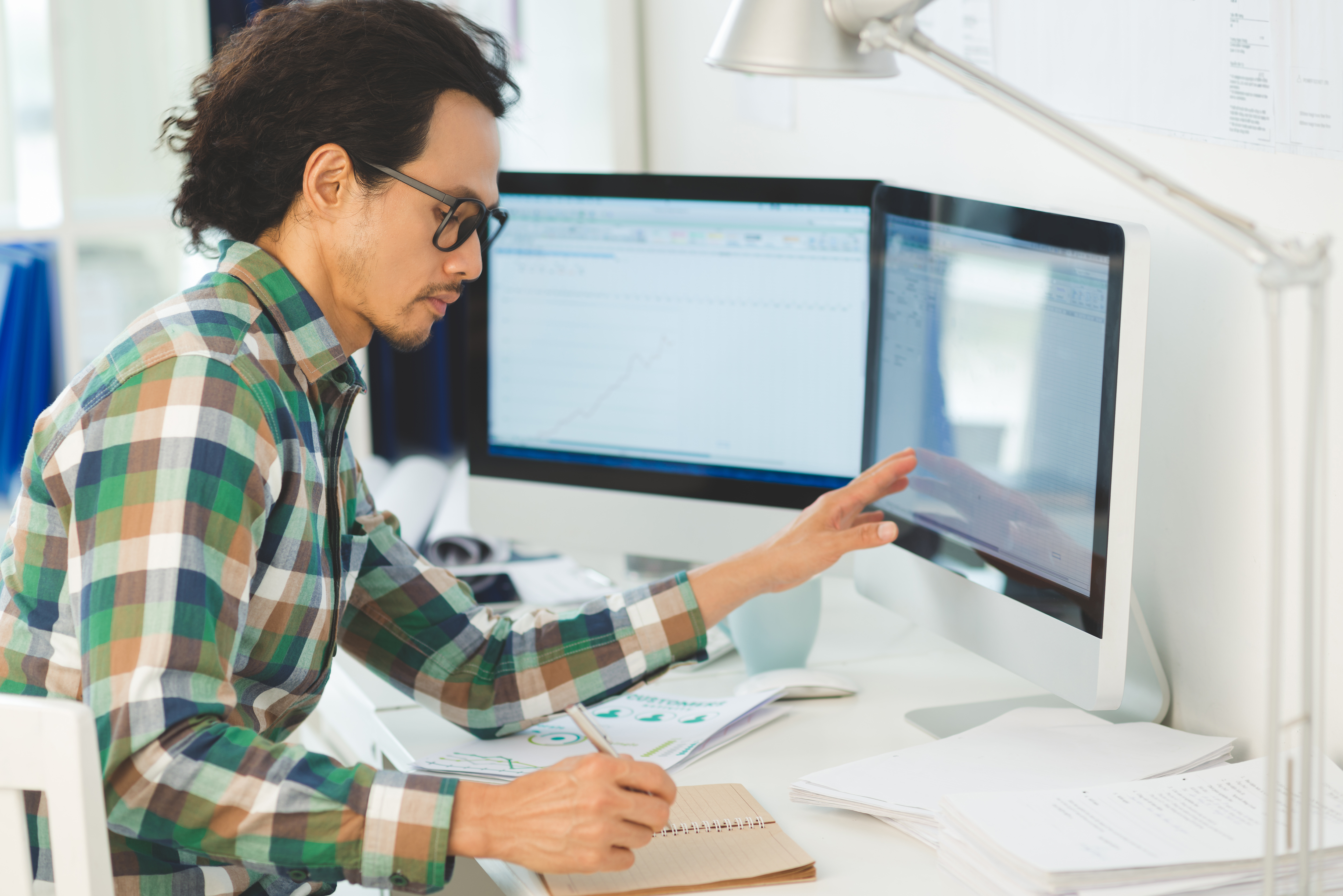 a man sits working independently at a computer