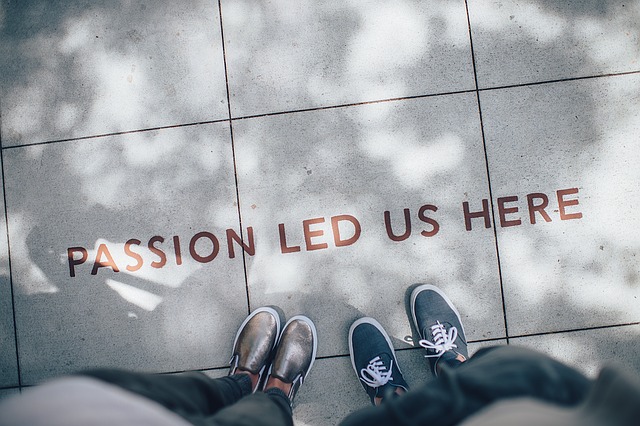 Picture of the shoes of two people standing on tile that reads, 