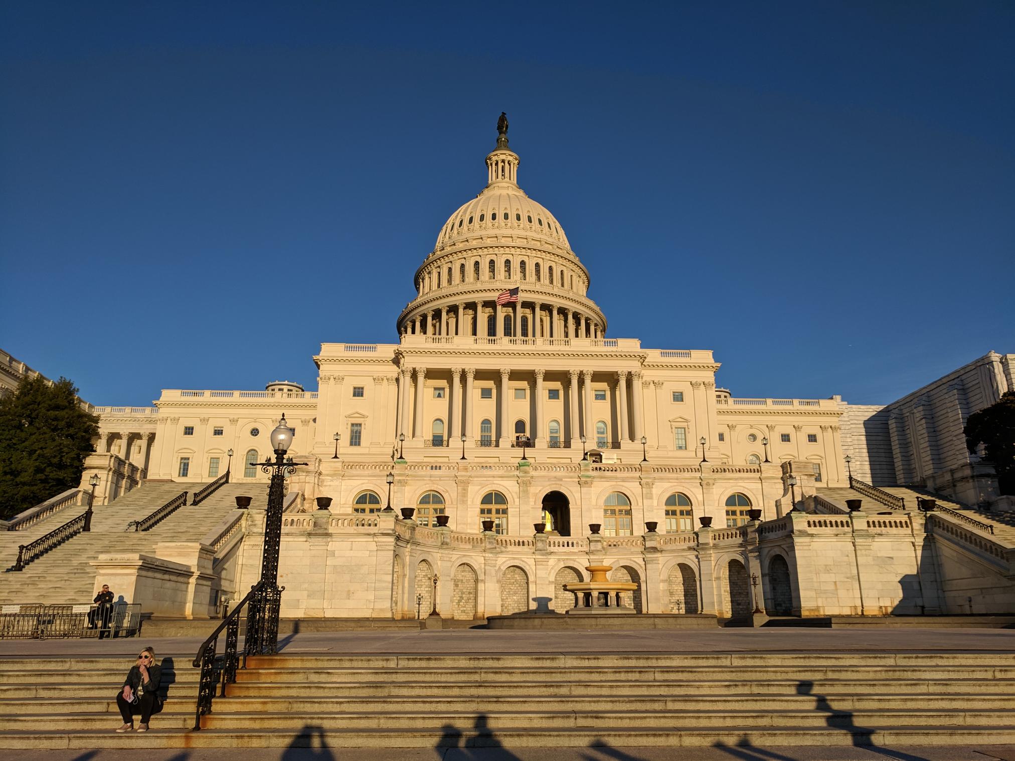 Picture of the capitol building with the sun shining on it.