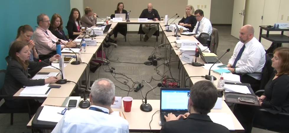 Picture of people discussing negotiated rulemaking. People are sitting at tables that are organized in a rectangle. That's Russ Poulin on the left.