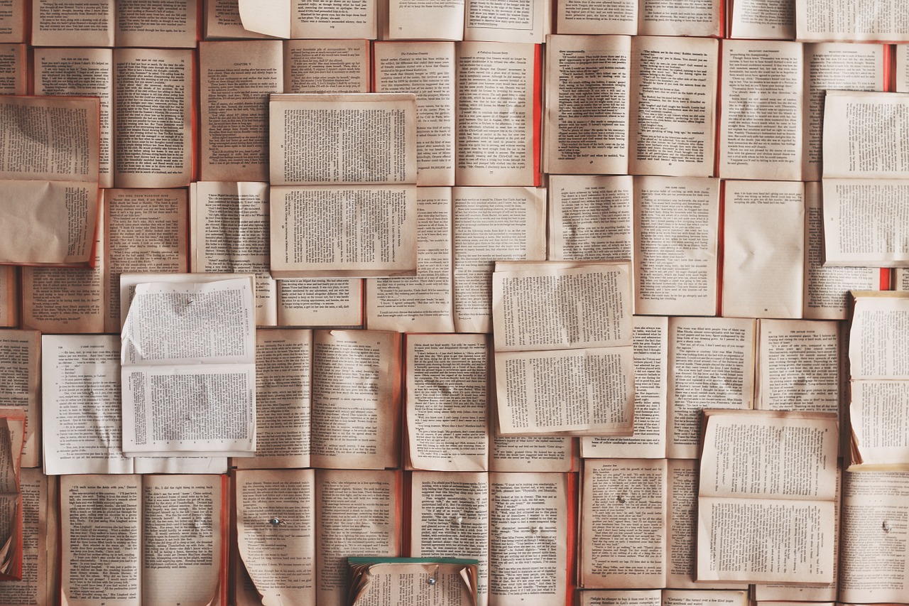 Many open books in a pile