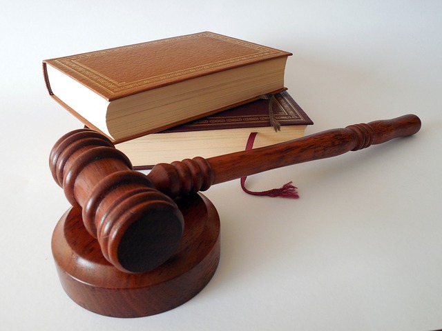 PIcture of judge gavel placed beside two books.