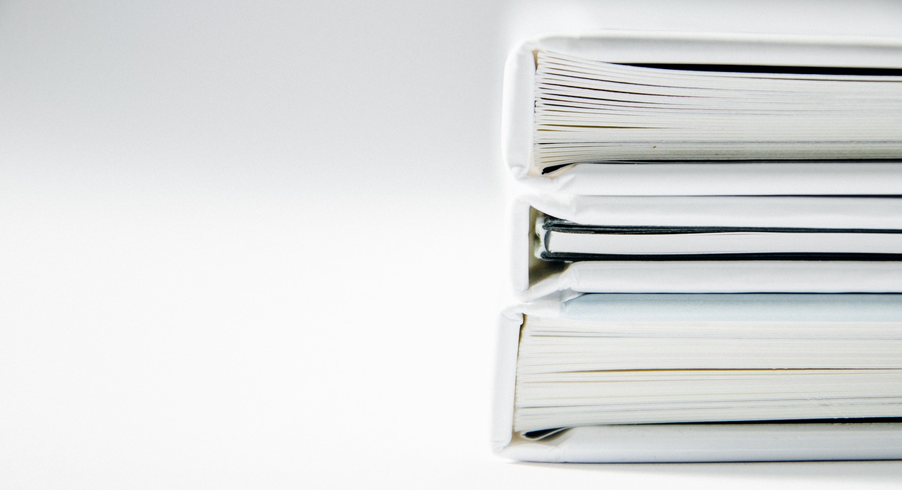 Three white books stacked