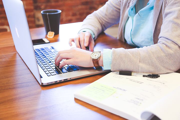 A person typing on a lapop