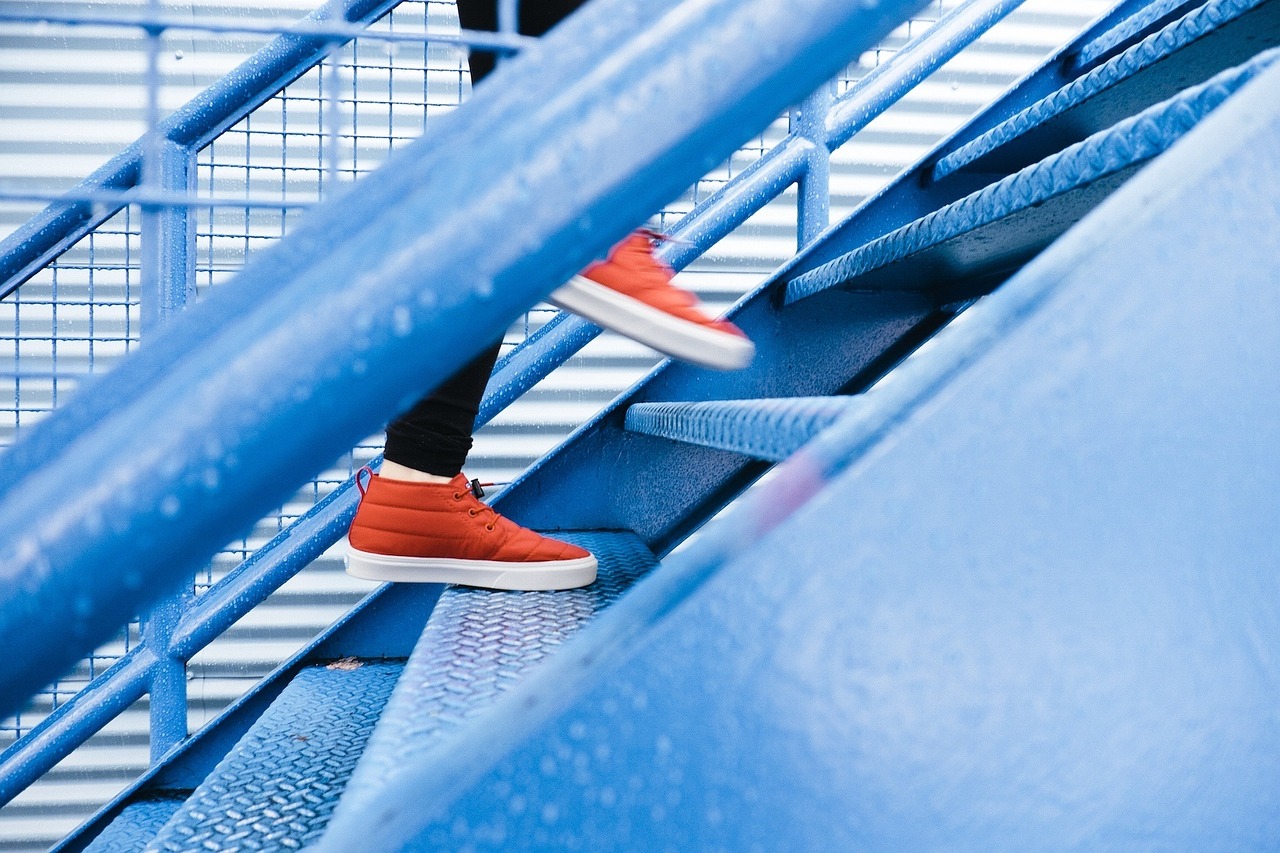 someone running up metal steps