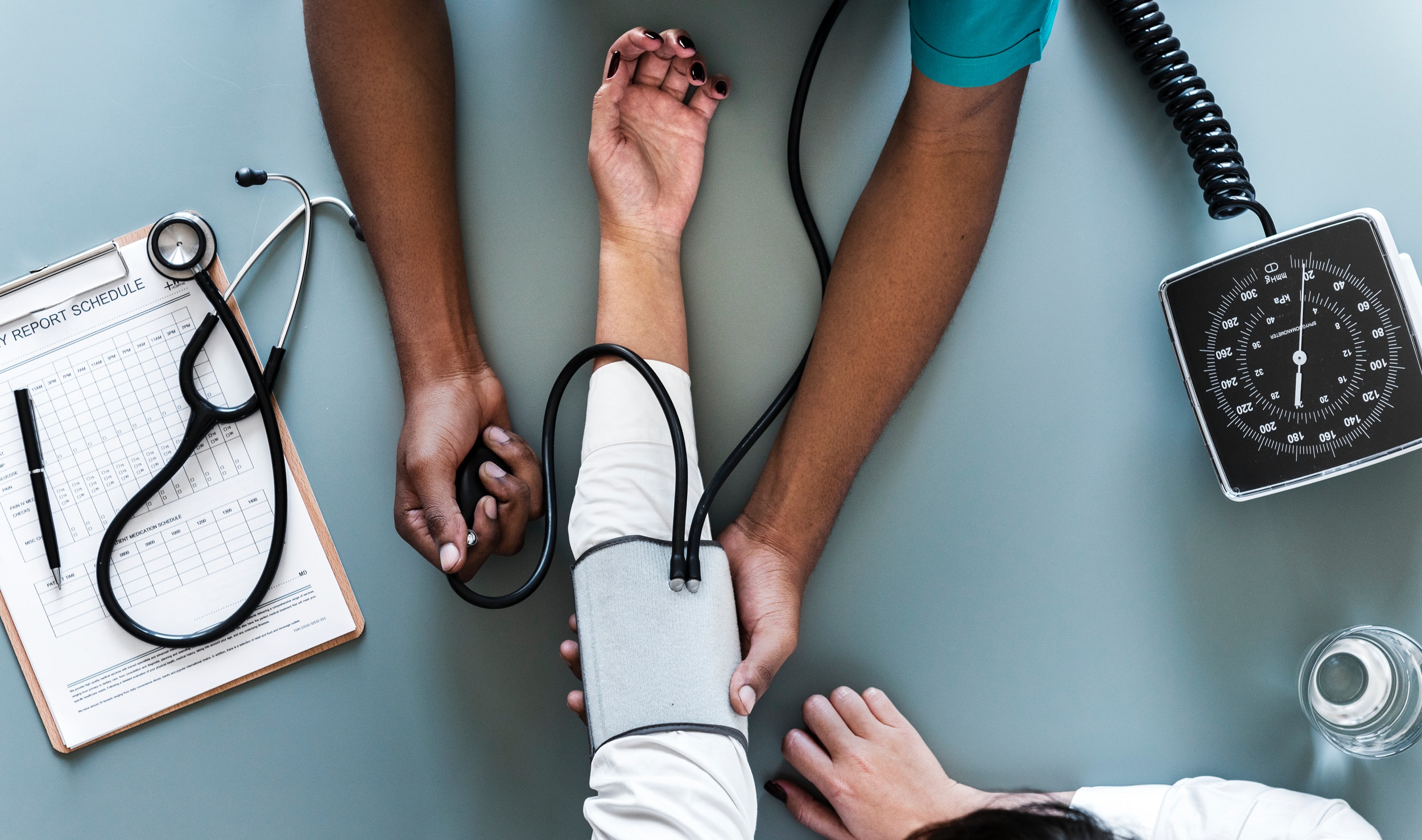 A medical personnel takes a patient's blood pressure