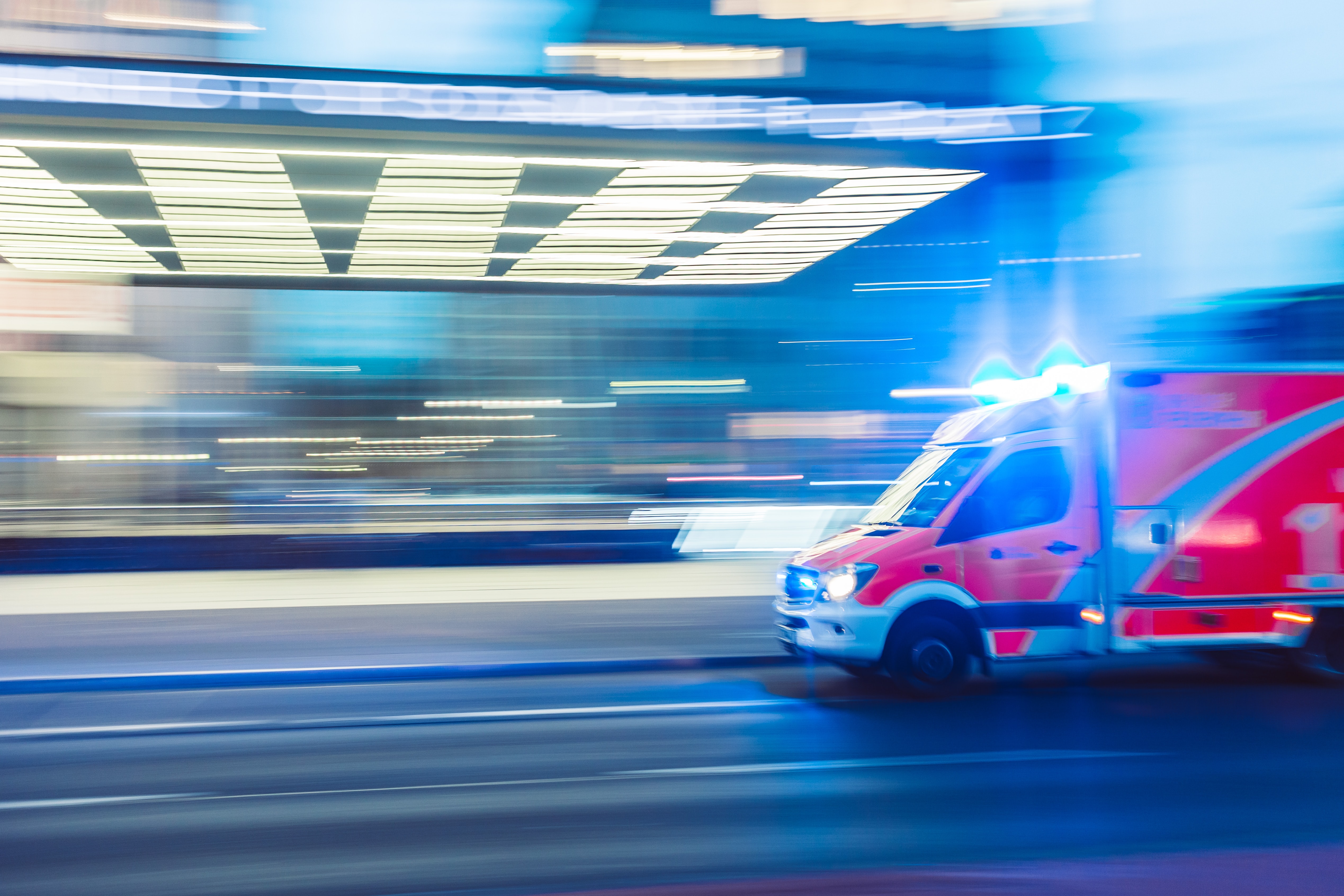 an ambulance travelling quickly on a road