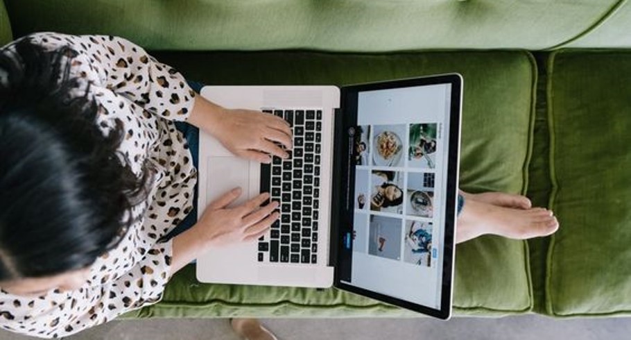 a woman working on a laptop showing video conferencing