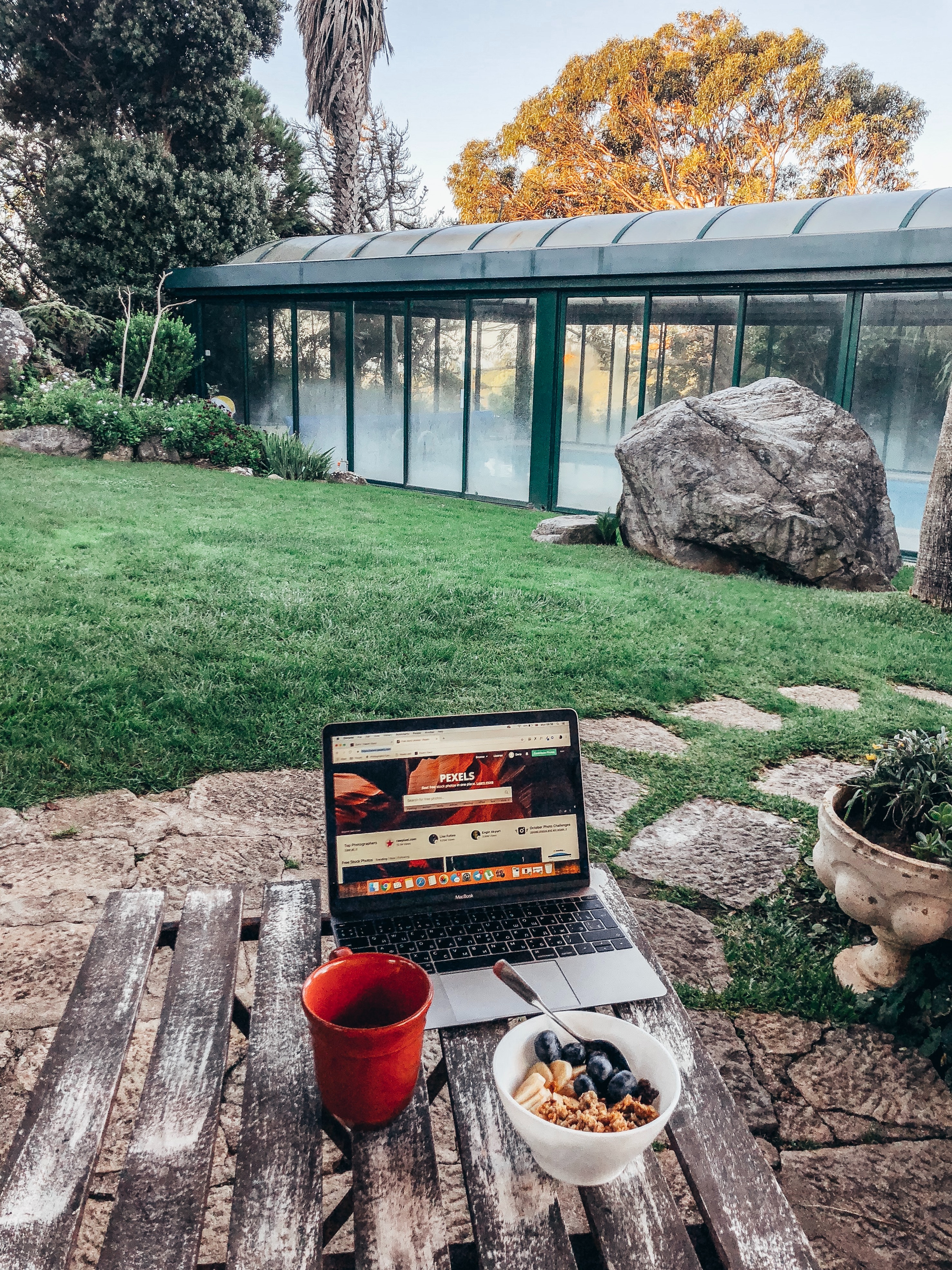  Turned-on Macbook Pro on Brown Table 