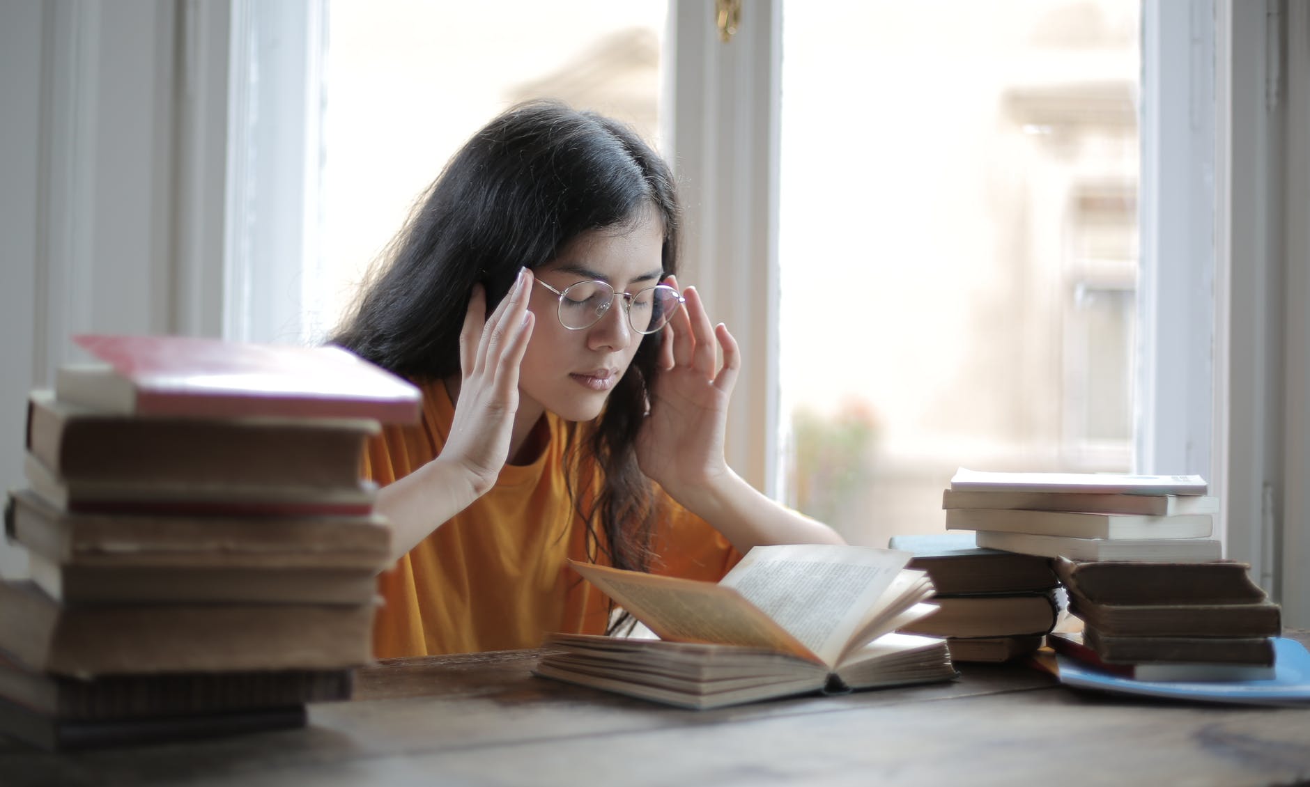 a student holds their head while looking at a computer