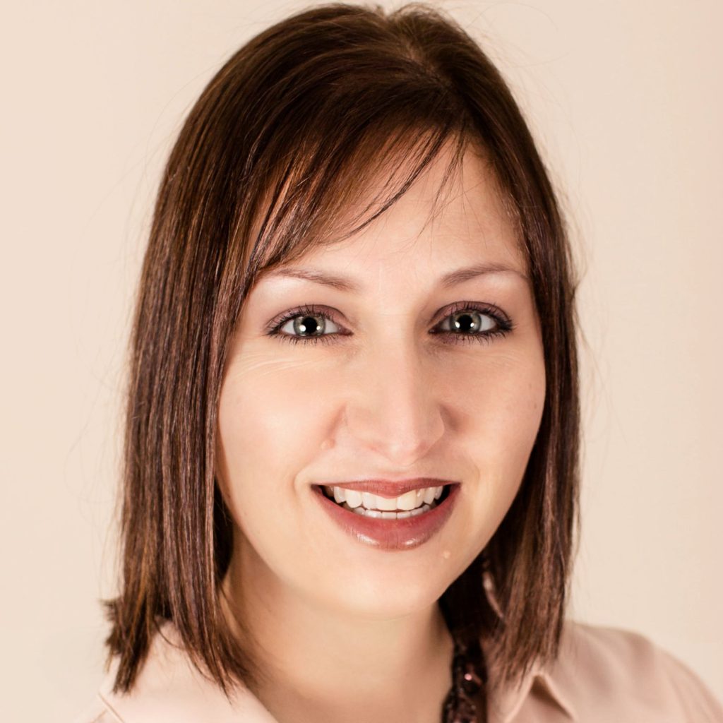 Lesley Voigt - young woman with brown hair smiles at the camera.