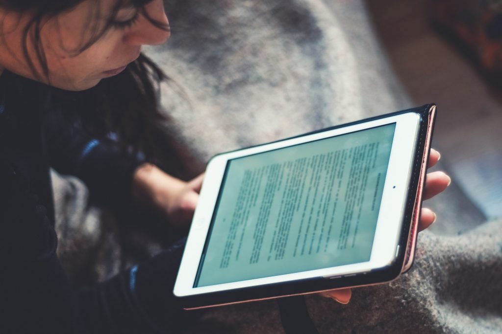 a young person reading from a tablet