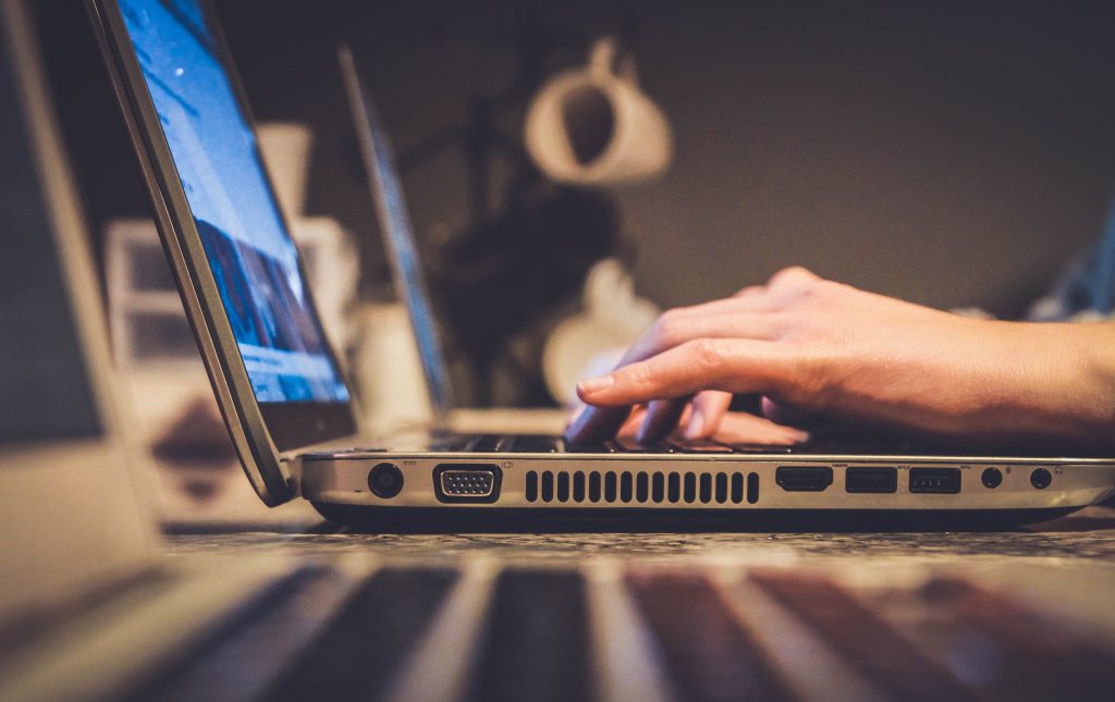 a person typing on a laptop computer