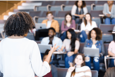 Women speaking in front of a college classroom