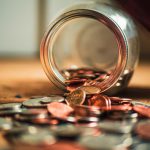 Image of a jar spilling coins onto a table