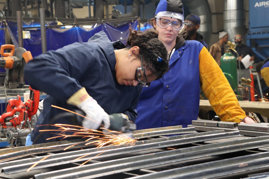 Photo of two students in a welding class.