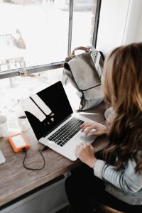 Photo of a young woman using a laptop